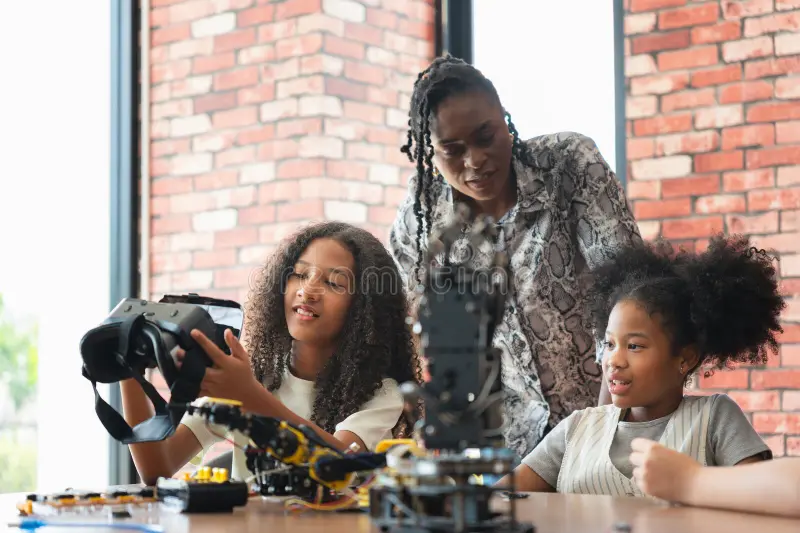 teacher guiding girls robotics vr class young students exploring technology virtual reality robotics stem teacher 389103354